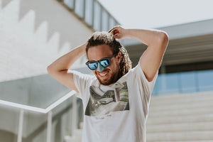 Young male wearing sunglasses and Nözscreen in shade blue